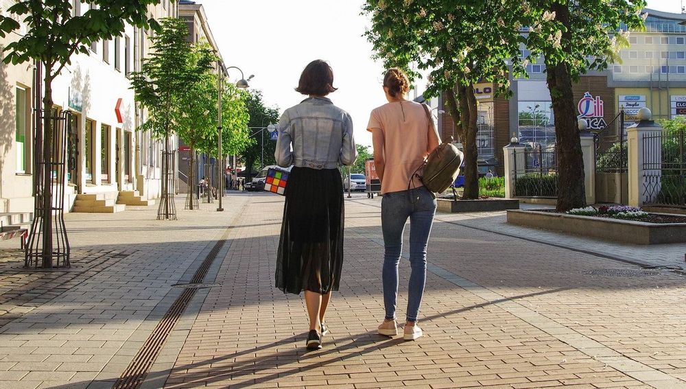 Image of two women walking in a city