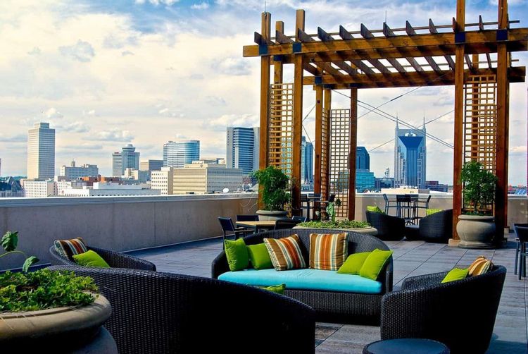 Image of a condo rooftop with a view of downtown Nashville in the background