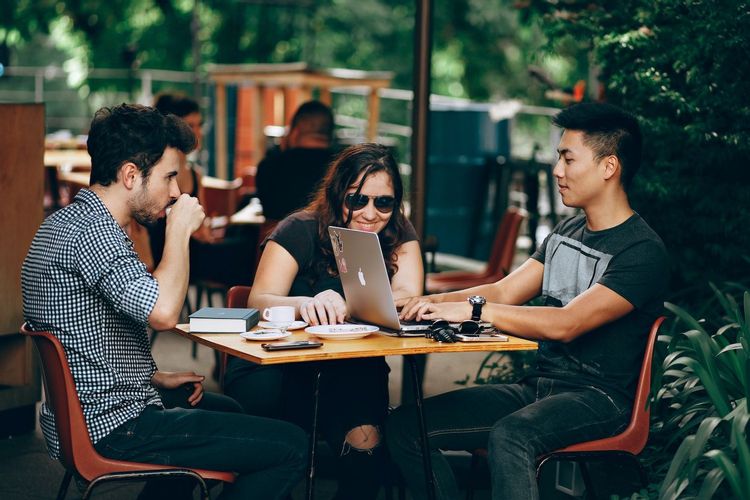 Image of three millennials sitting at a table