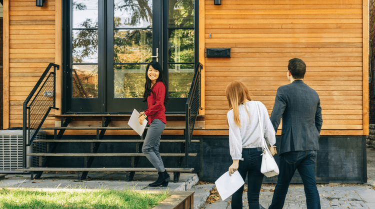 Image of a real estate agent showing clients a new home.