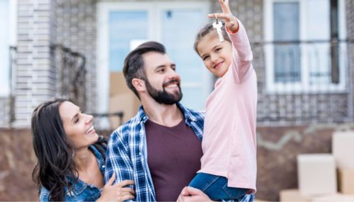 An image of a young couple and their daughter moving into their new home