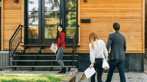 Image of a real estate agent showing clients a new home.