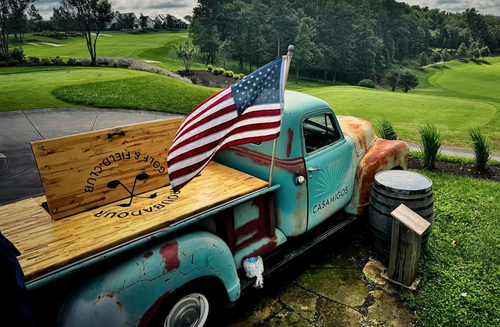 Image of an old pickup truck parked next to the Troubadour golf course